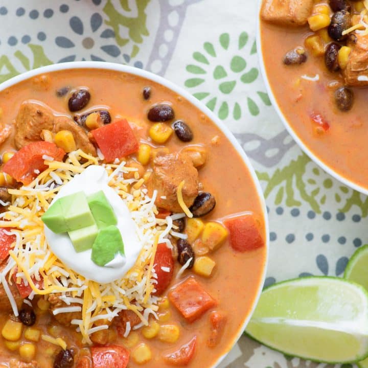 Cozy up with this tasty One Pot Baja Chicken Enchilada Soup! It's healthy, hearty, and full of robust flavor! If you only ever make one mexican soup recipe, it should be this one!